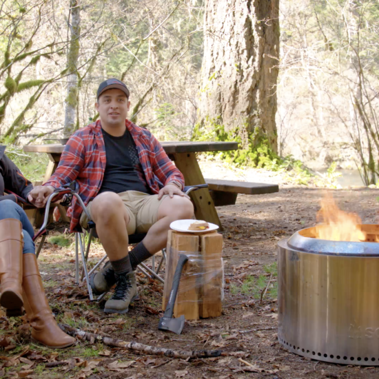 Christopher and Jessica Leal sitting with their Solo Stove Yukon