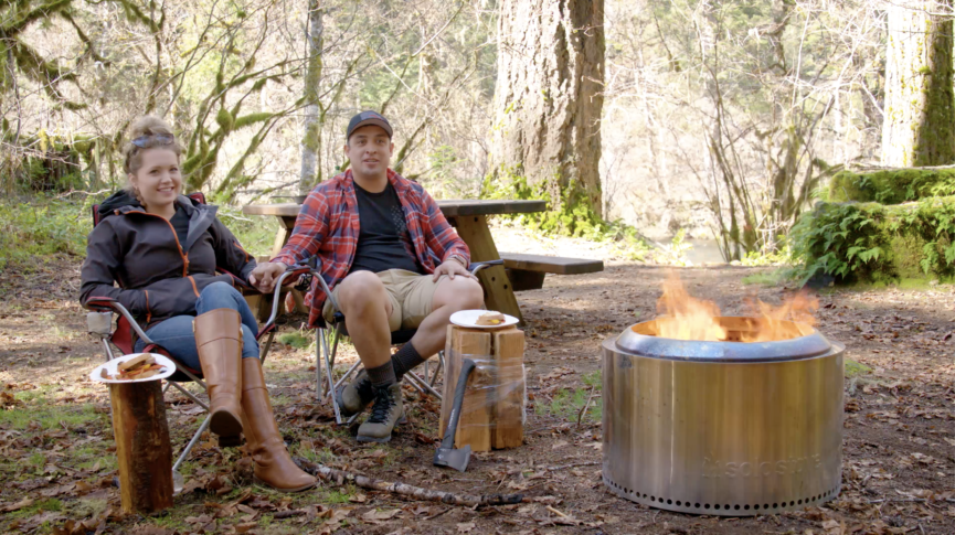 Christopher and Jessica Leal sitting with their Solo Stove Yukon